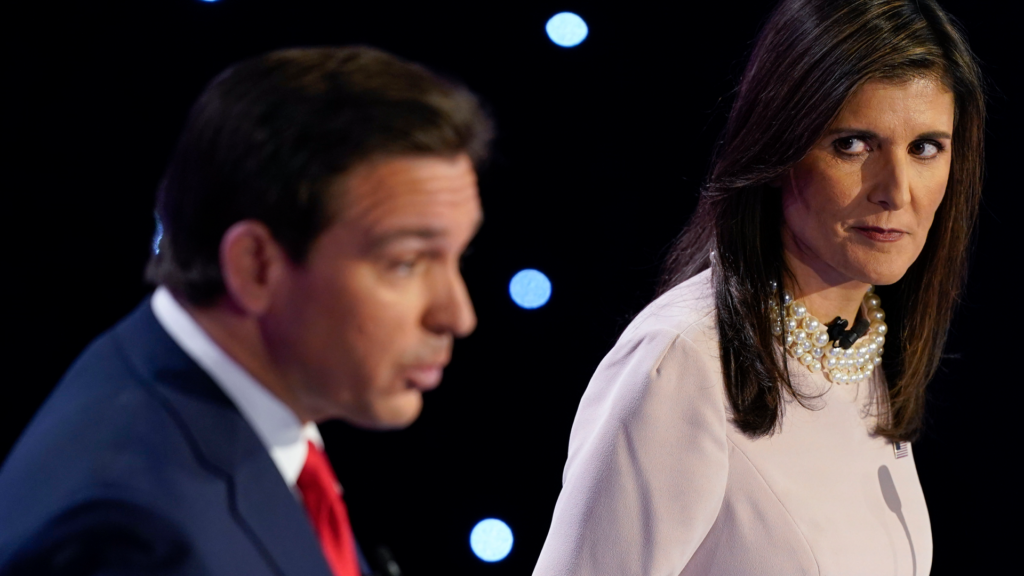 Former UN ambassador Nikki Haley, right, watches Florida Governor Ron DeSantis, left, at the CNN Republican presidential debate at Drake University in Des Moines, Iowa, on Wednesday, January 10, 2024